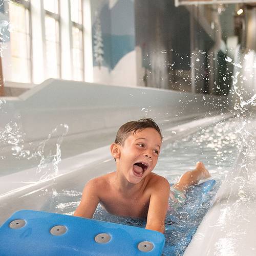 Girls floating on a tube in lazy river of waterpark