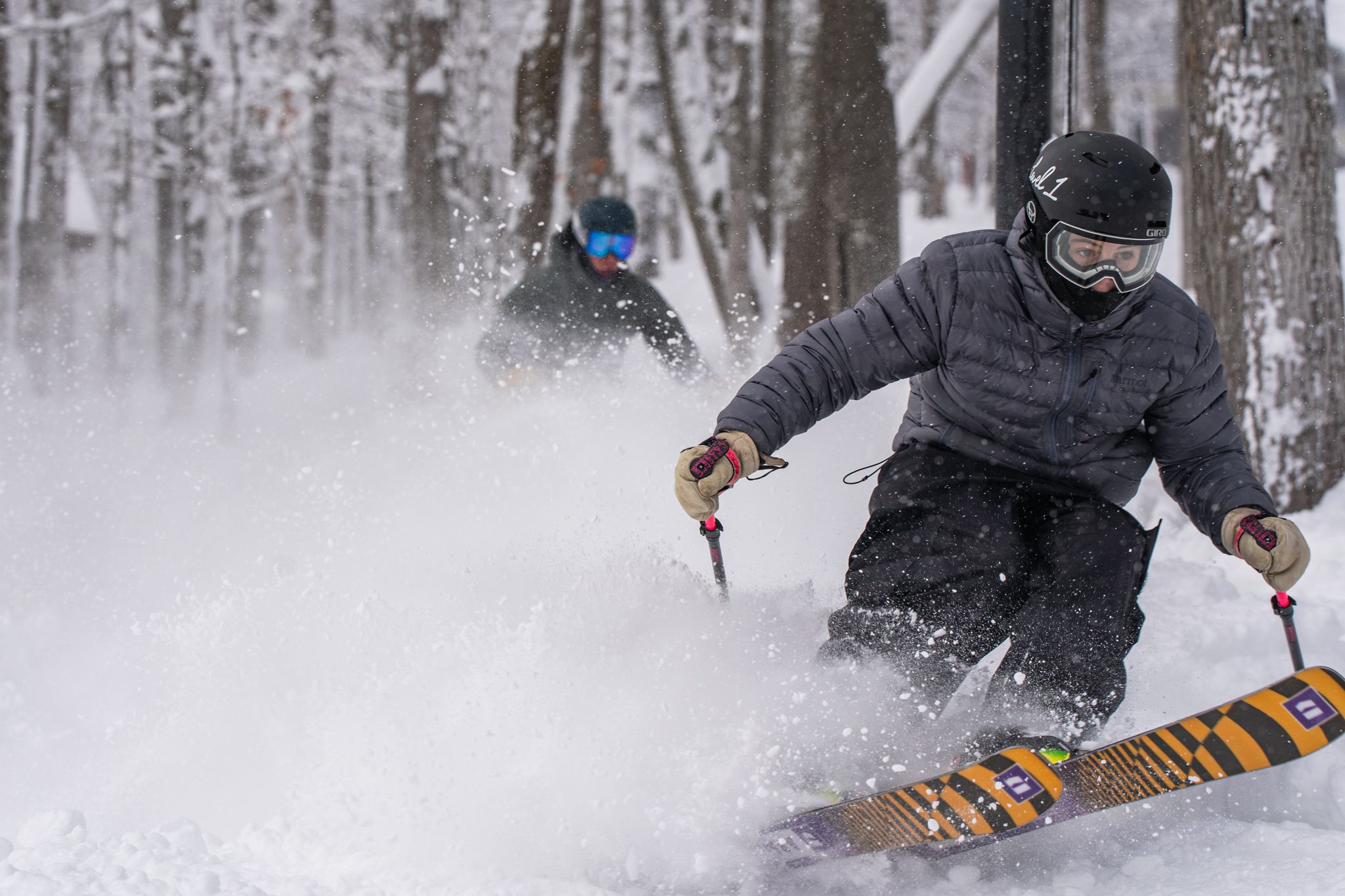 two skiers ripping through powder