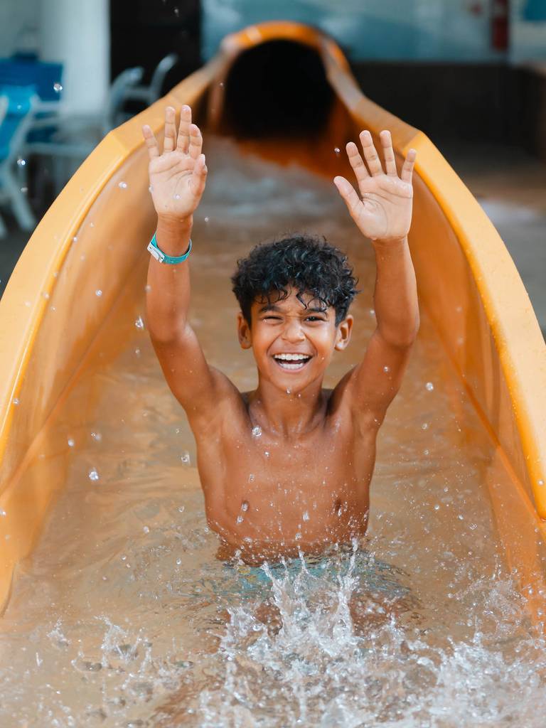 little boy in pool at waterpark