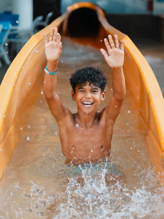 boy hands up waterpark