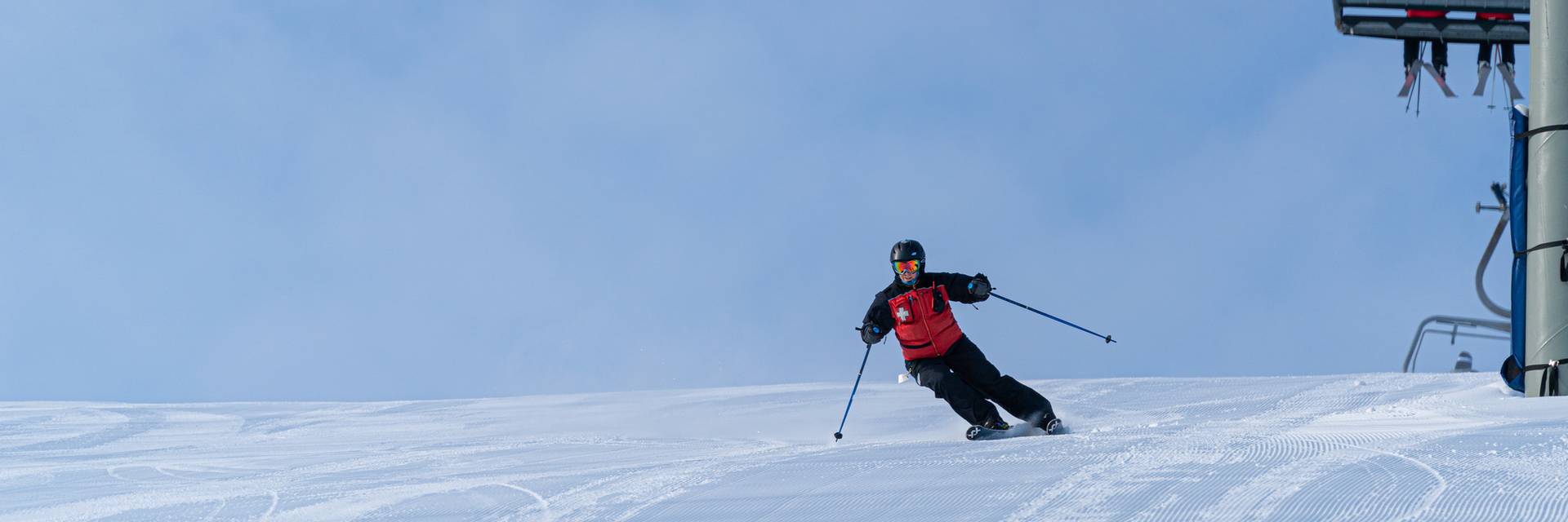 Ski Patrol member riding down mountain