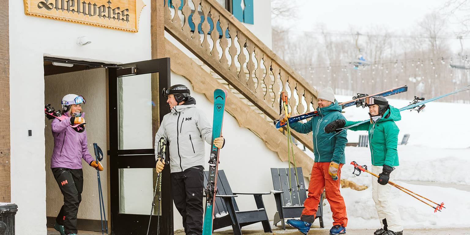 Skiers walking out of the Mountain Grand Lodge and Spa
