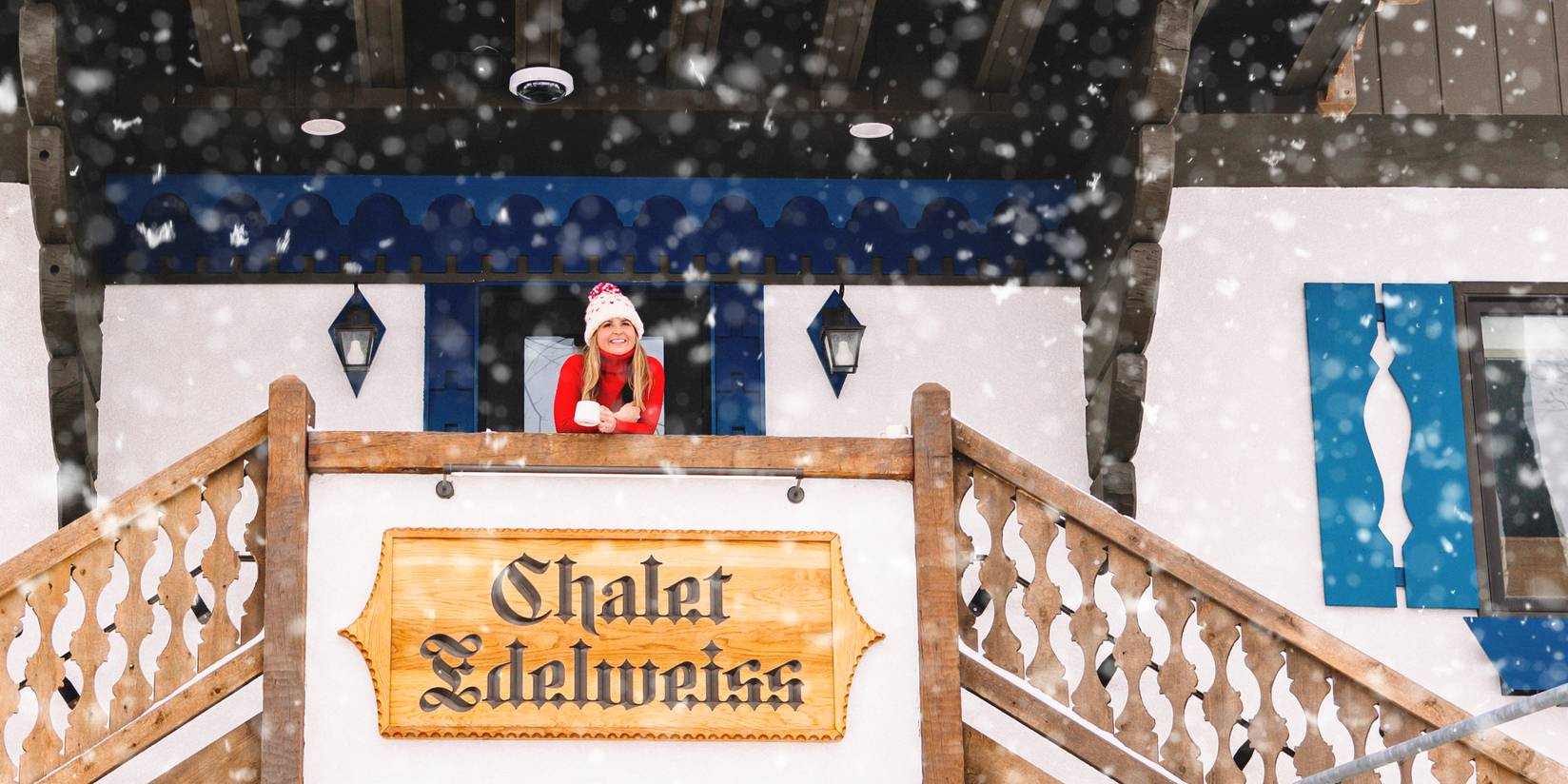 Woman standing on top of outdoor staircase at Chalet Edelweiss in the snow