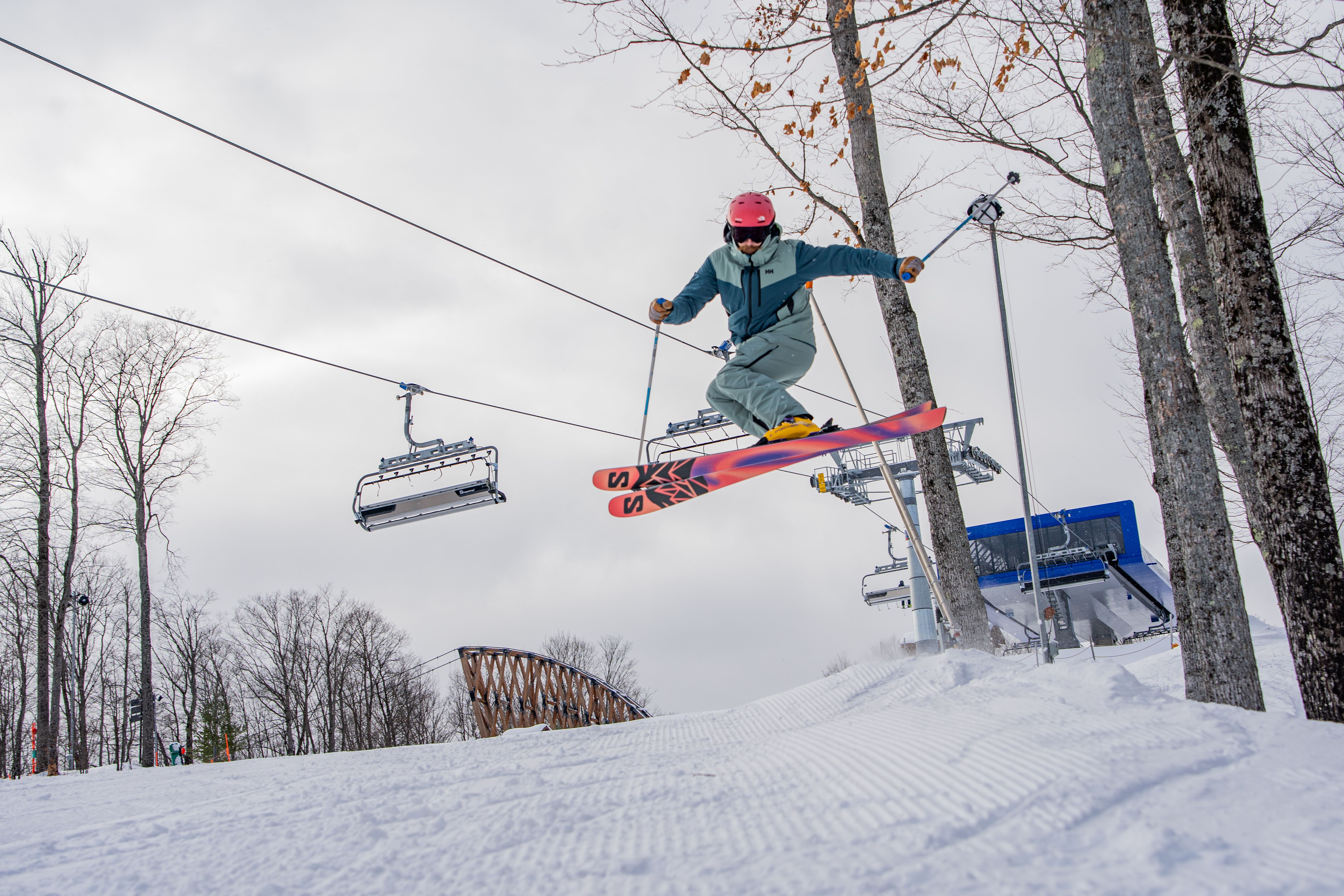 skier hitting jump in front of Disciples 8