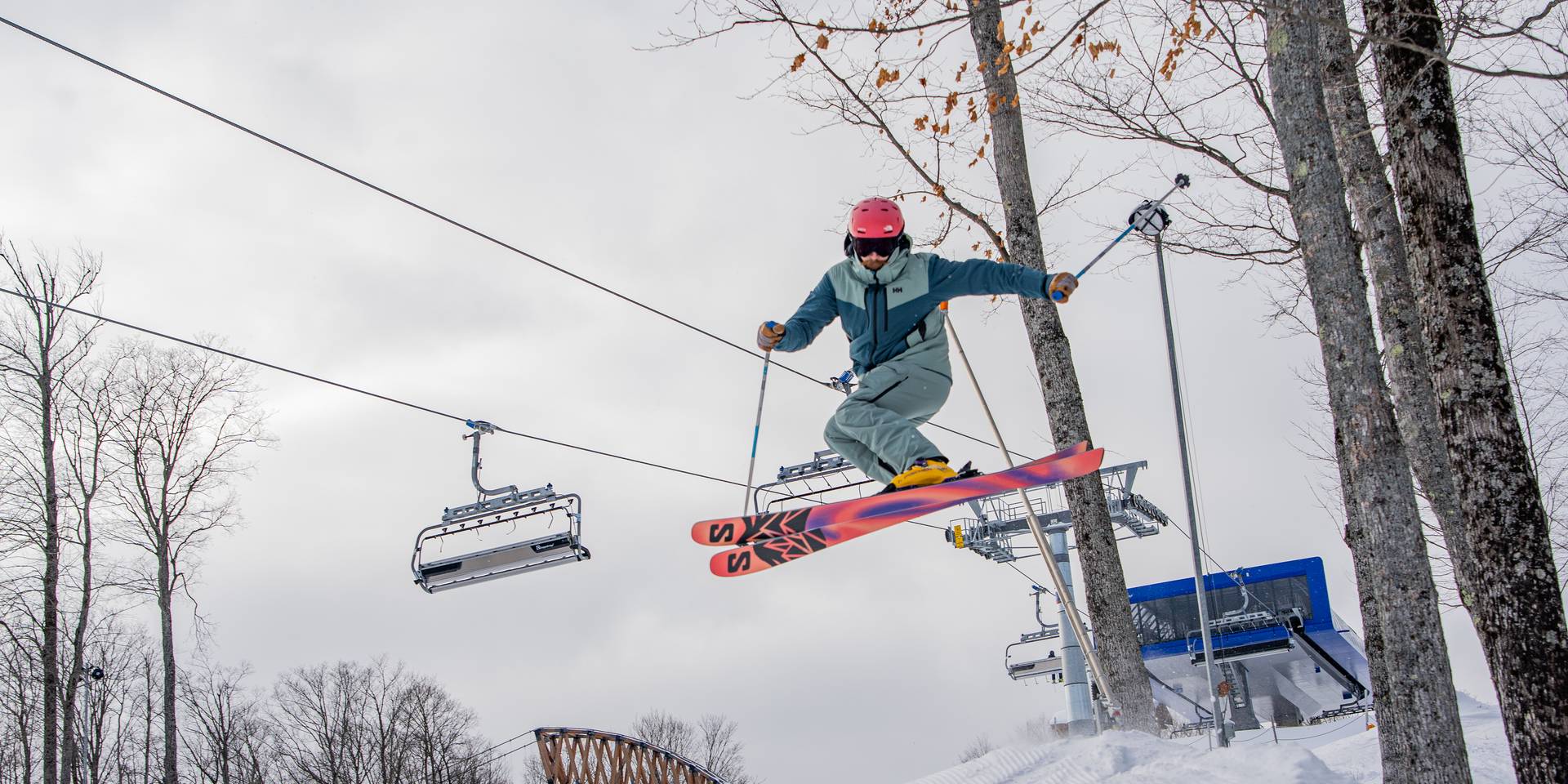 skier hitting jump in front of Disciples 8