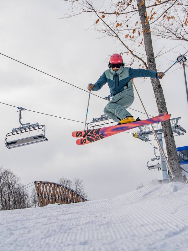 Two skiers having a drink outside Chalet Edelweiss