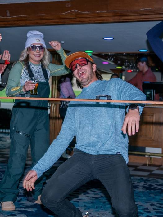 person doing the limbo with a shotski