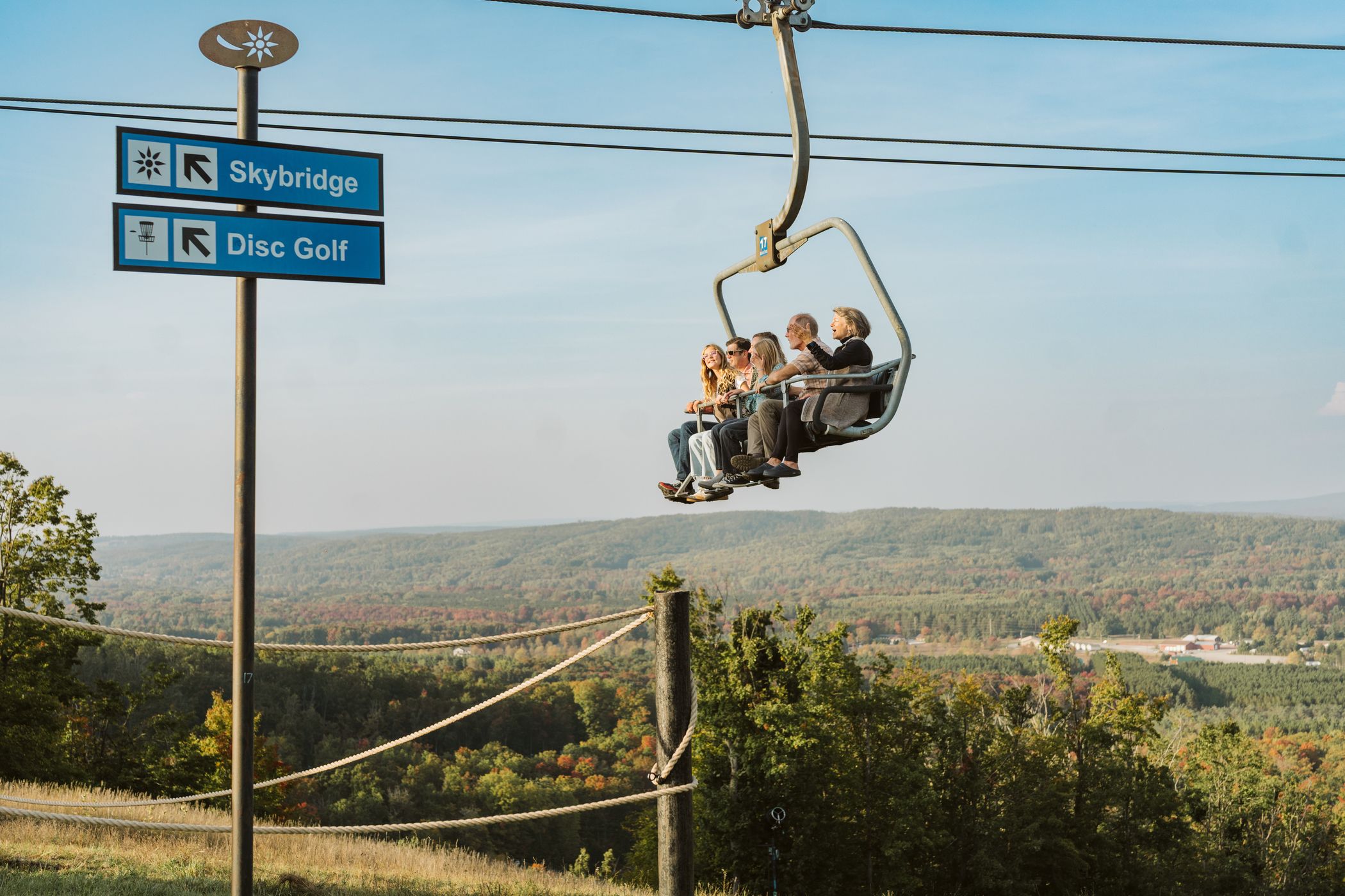 Family riding up the Mountain Express scenic chairlift