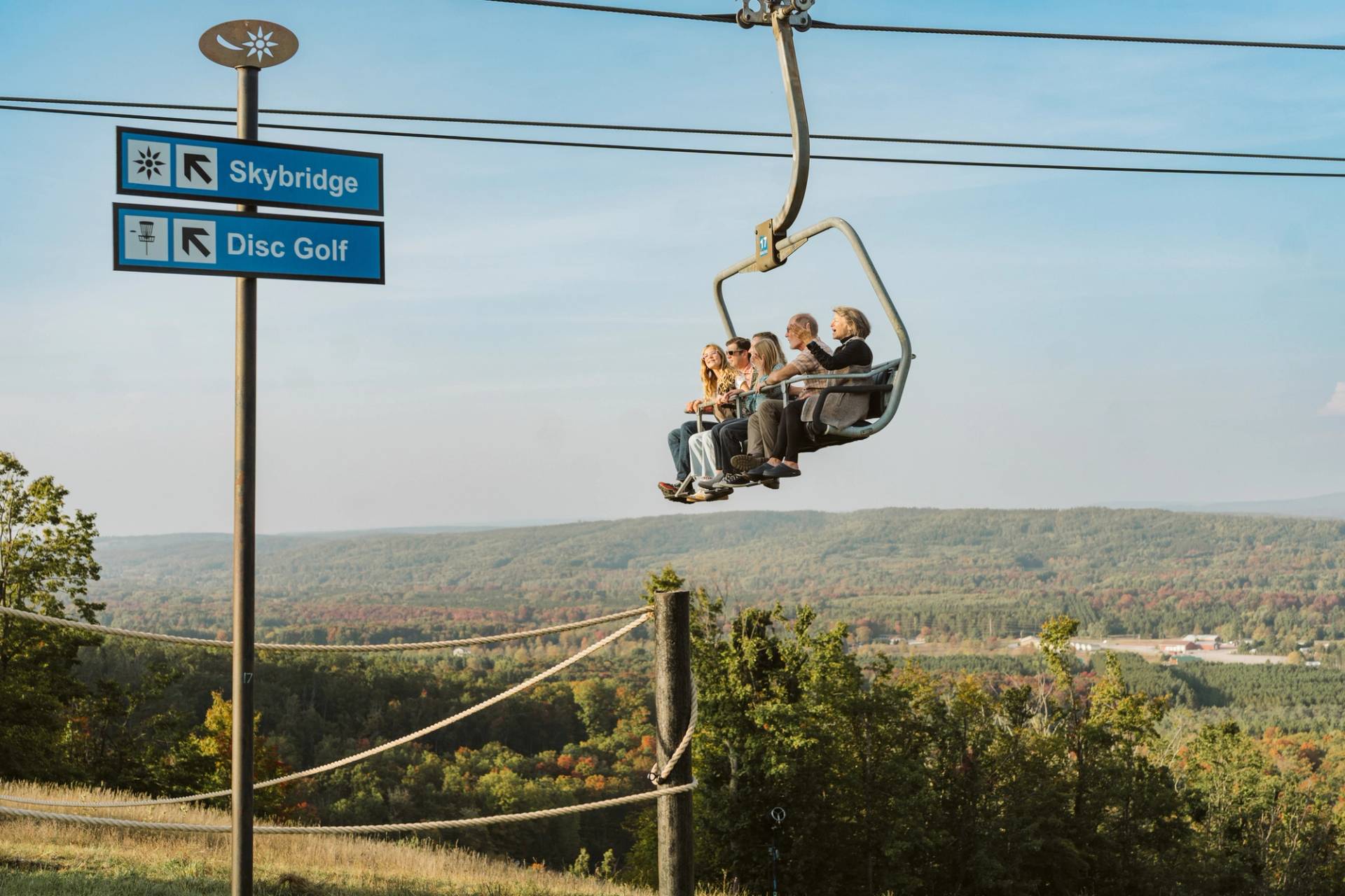 family riding scenic chairlift