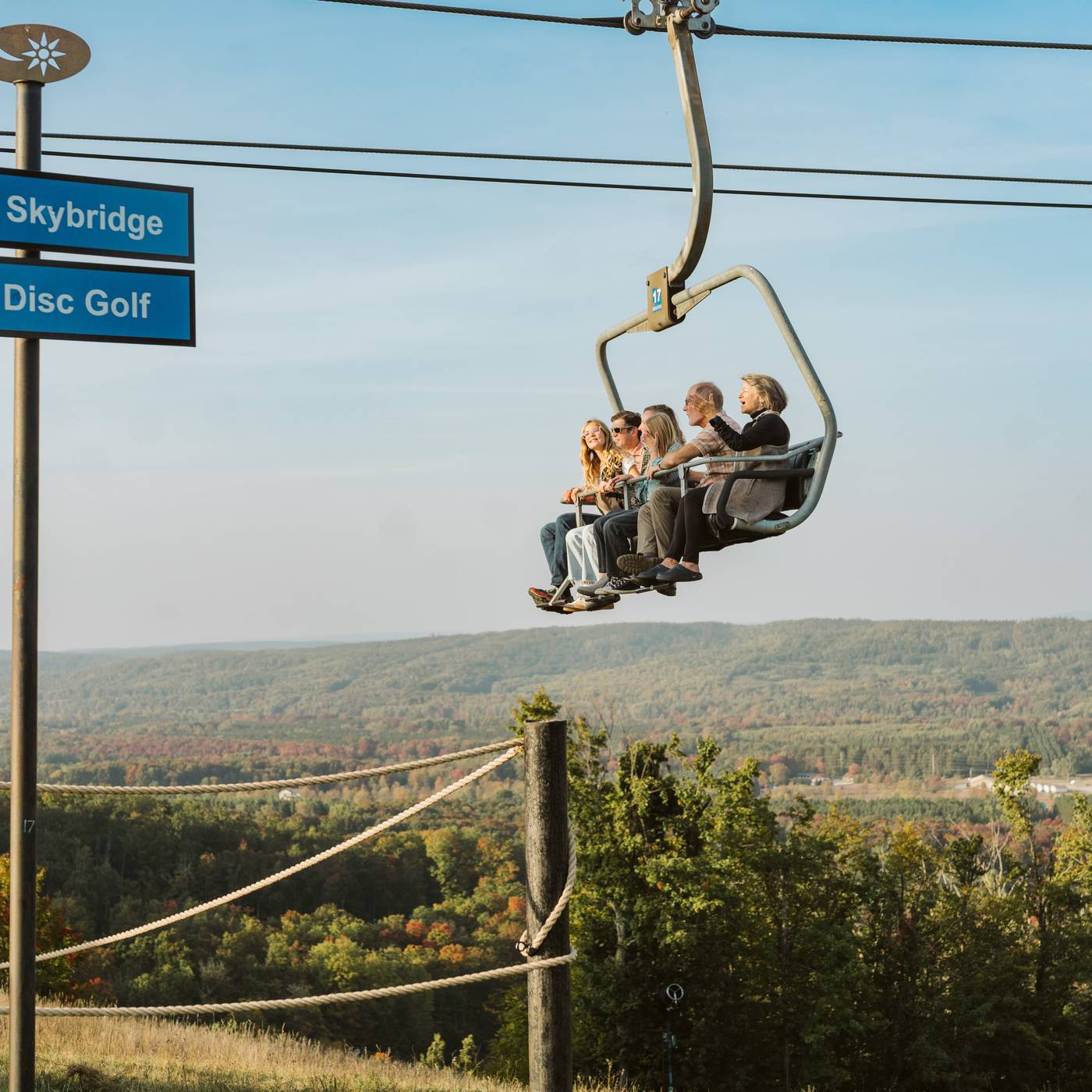 Family riding up the Mountain Express scenic chairlift