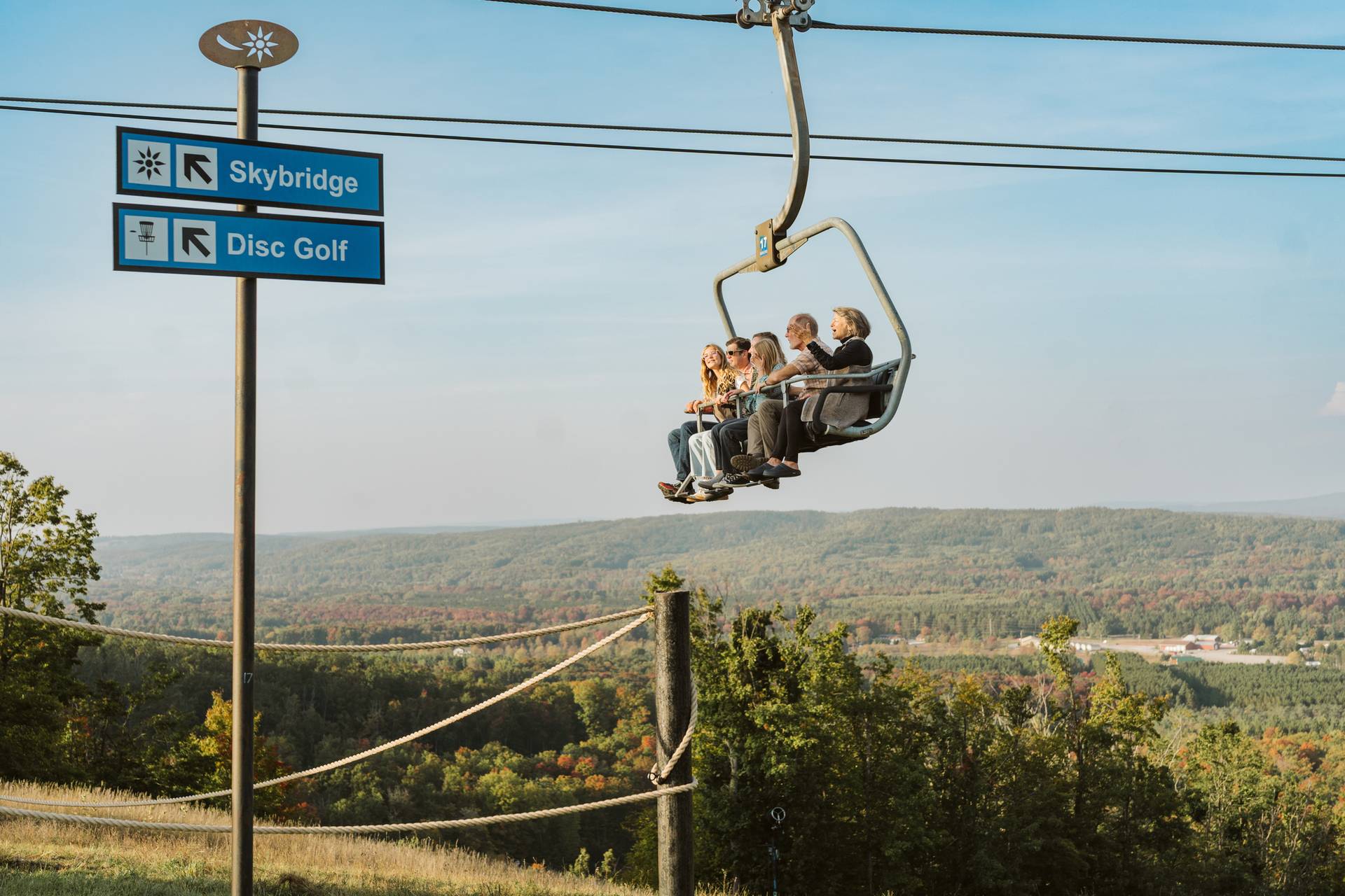 family riding scenic chairlift