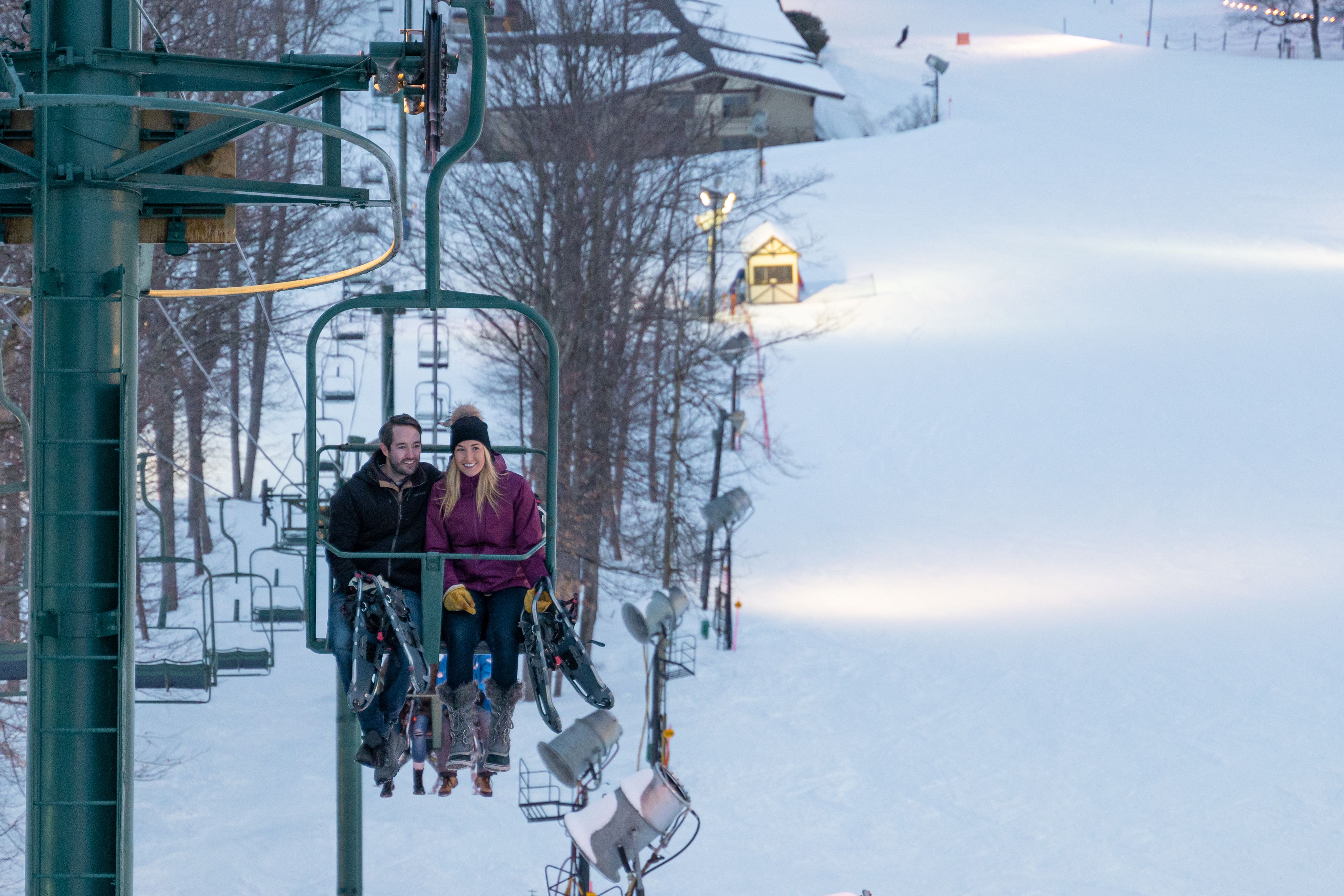couple on lift with snowshoes