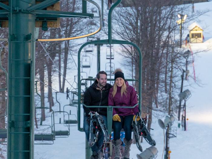 couple on lift with snowshoes