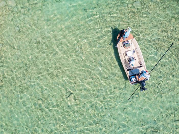 Drone photo of people fishing off a boat