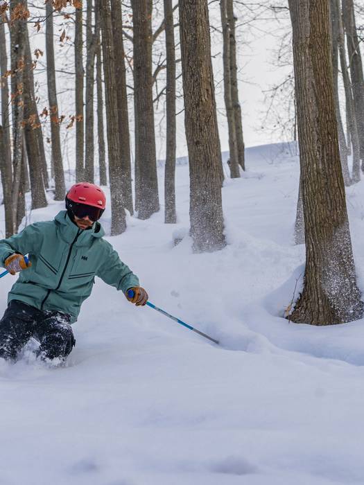 man skiing through the trees