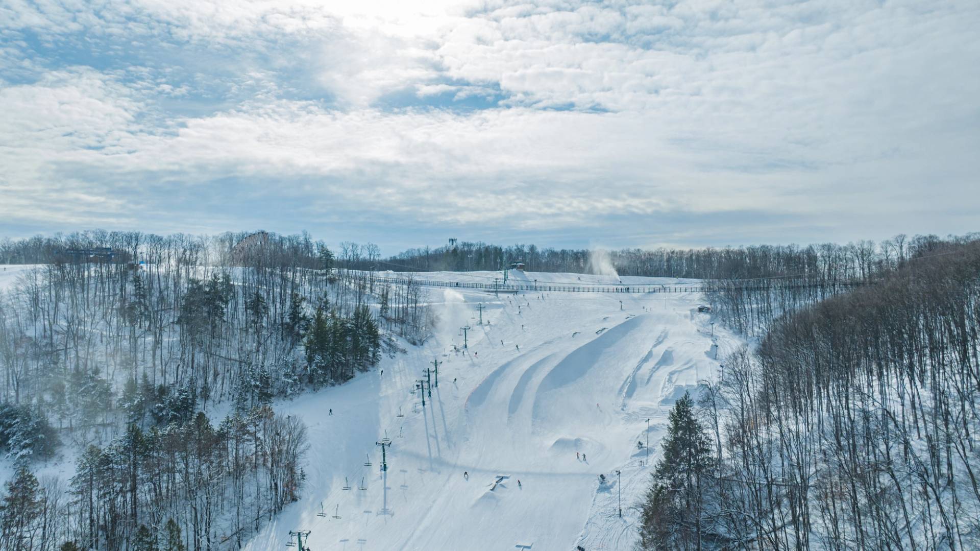 View of SkyBridge Michigan over Ramshead terrain park with guests riding below