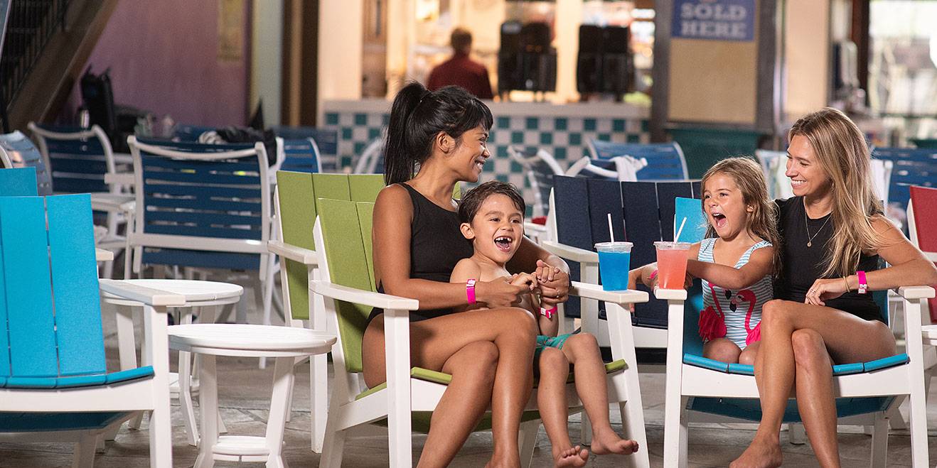 Mom and childrend enjoying drinks in Avlanche Bay