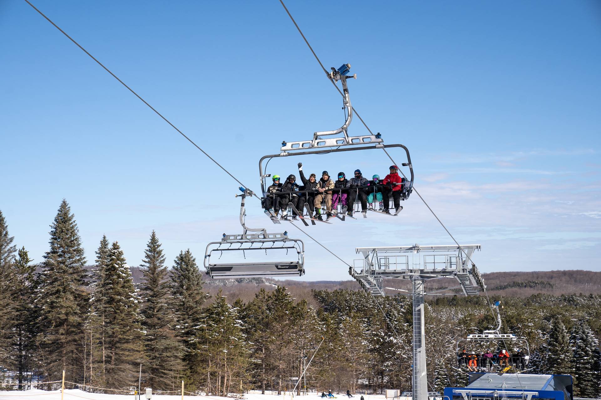 Group of Skiers riding the Disciples 8 Chairlift