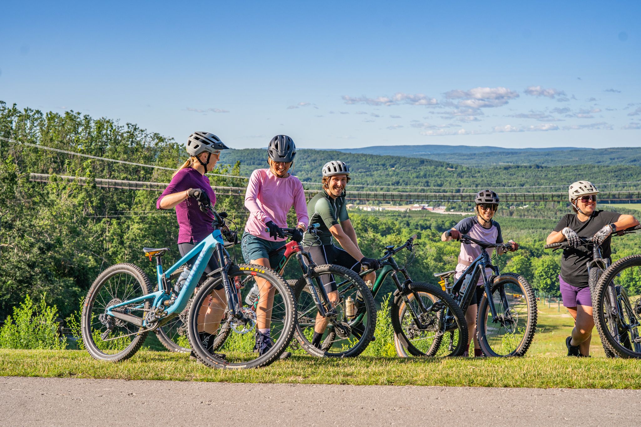 Group of friends mountain biking in summer