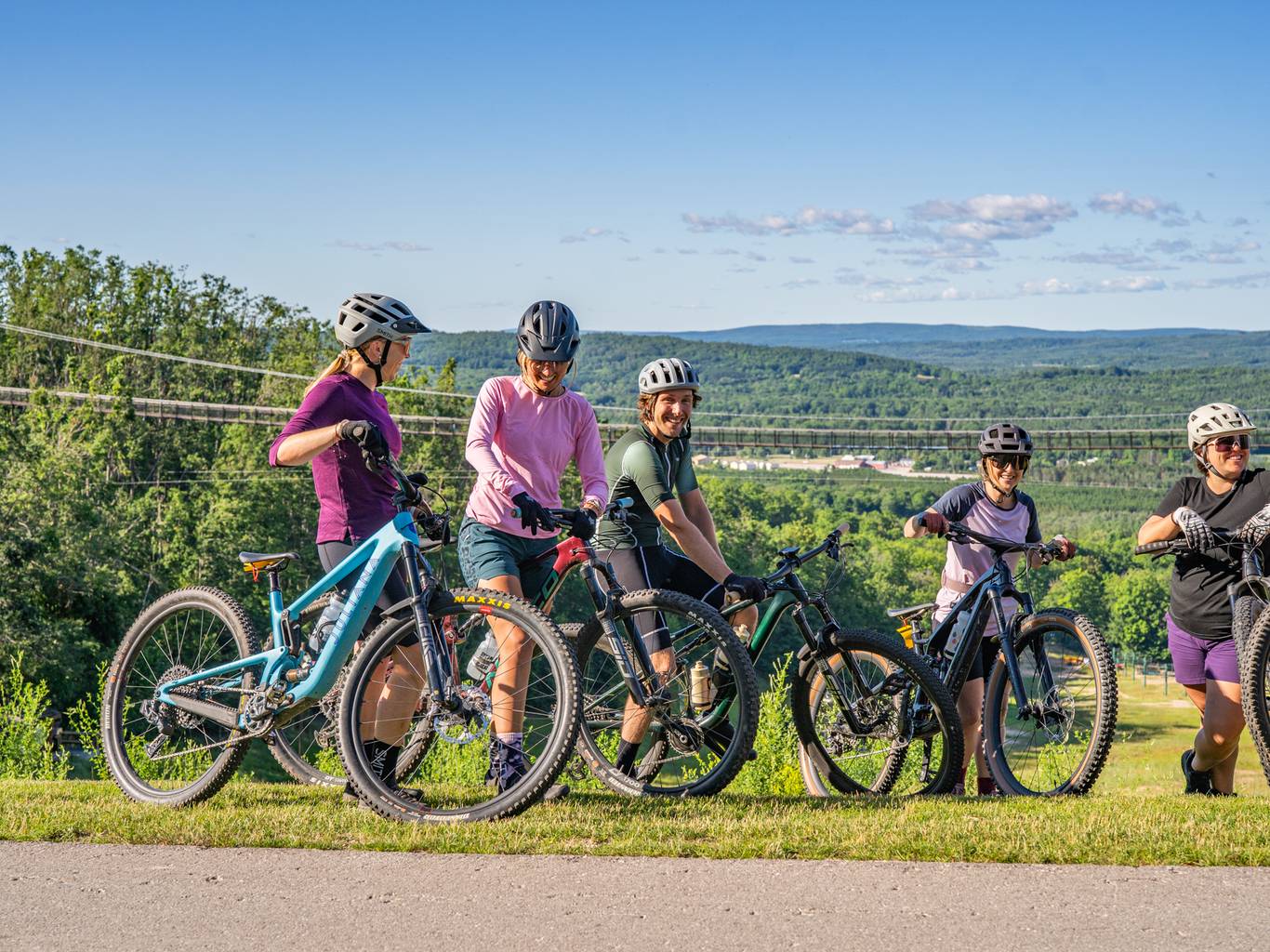 Group of friends mountain biking in summer