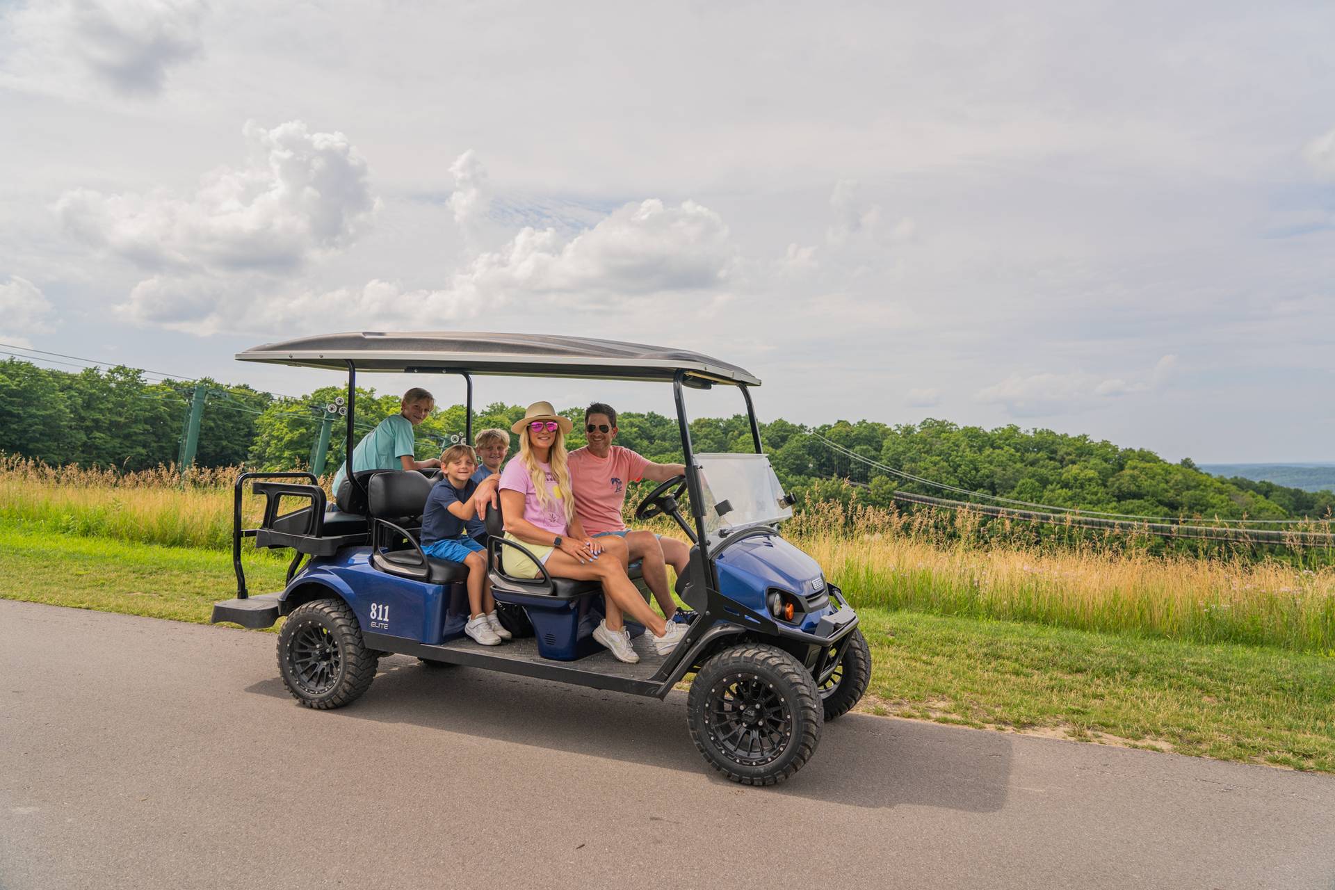 Family sitting on scenic cart overlooking SkyBridge Michigan