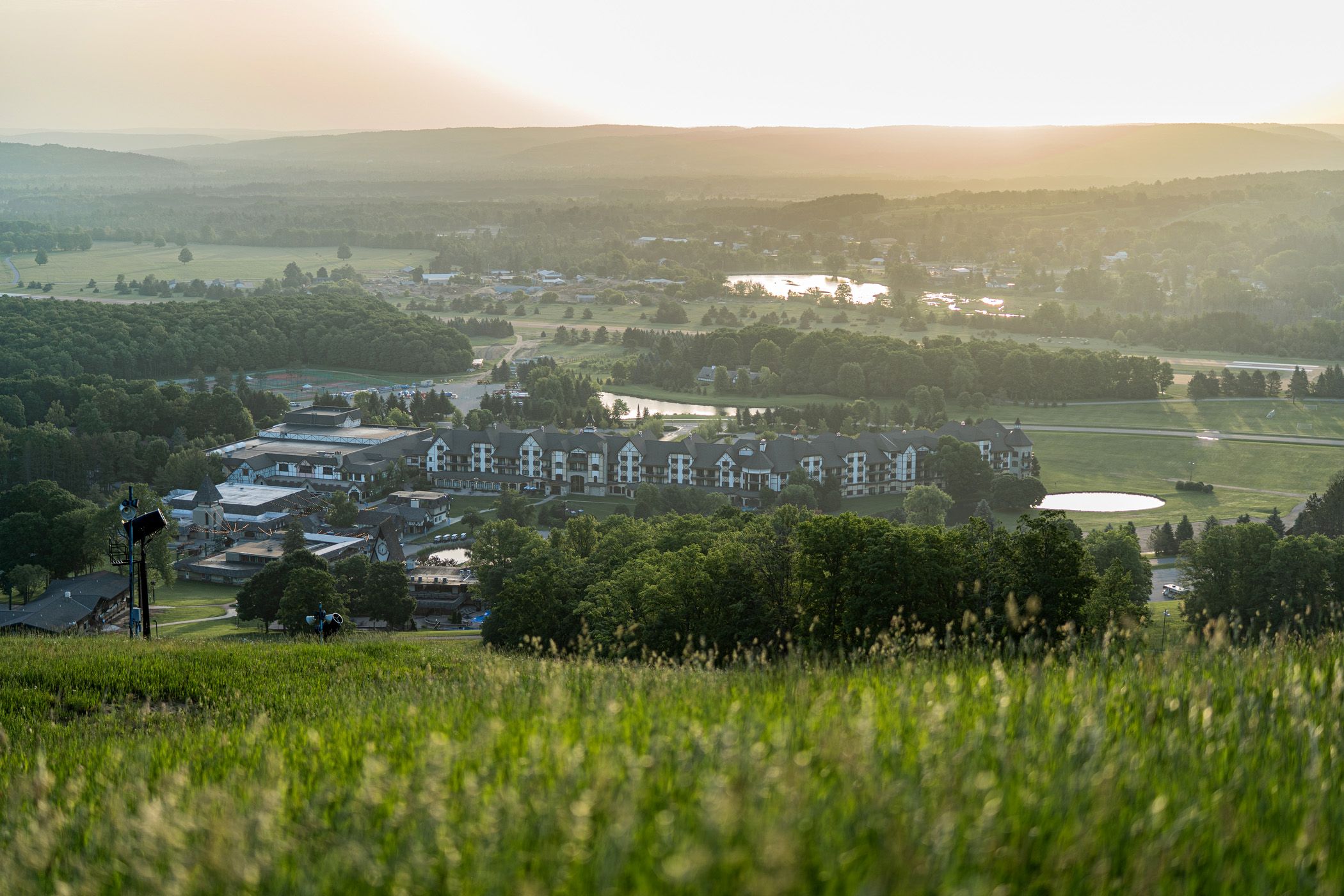 Arial shot of the village lande and lit up ski hills.
