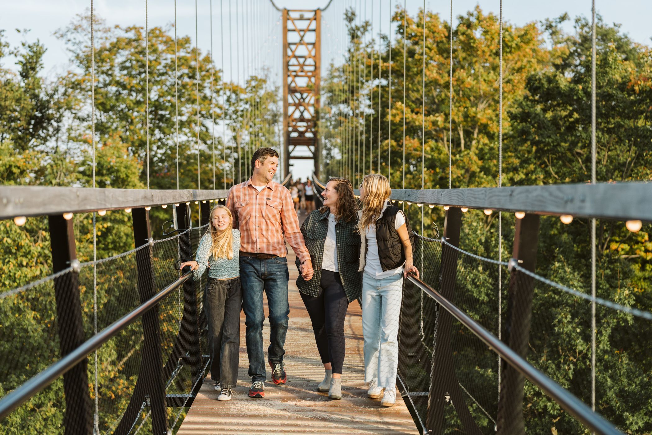Family walking across the skybridge with dad
