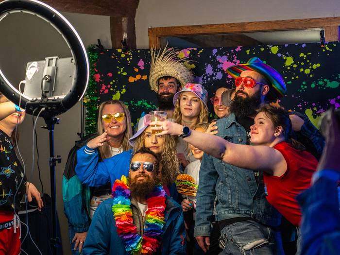 Friend group using photo booth at The Snowflake Lounge