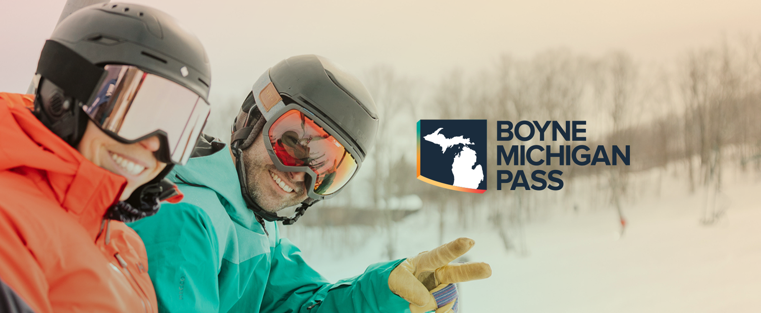 two skiers riding chairlift