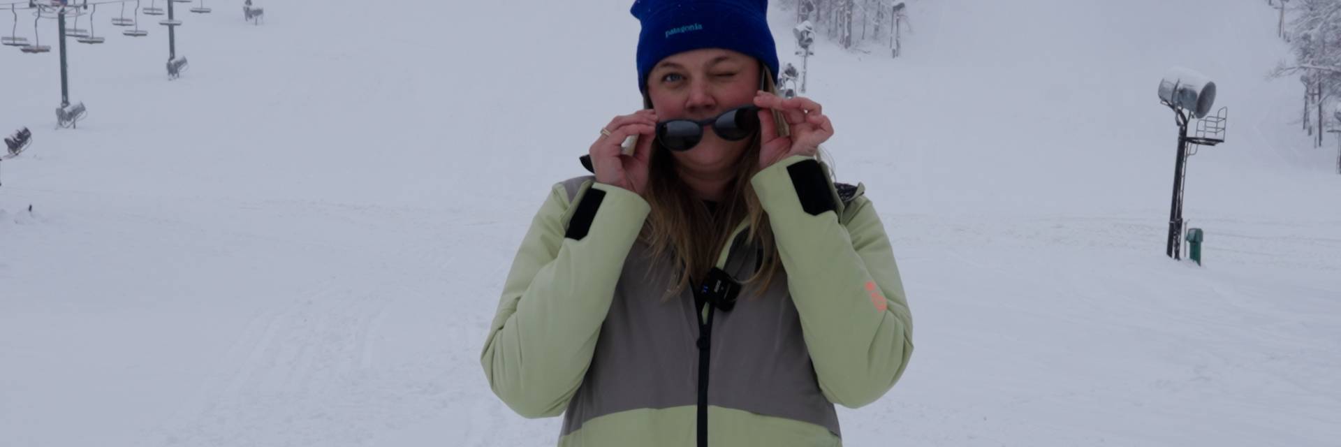 Woman on slopes winking at camera