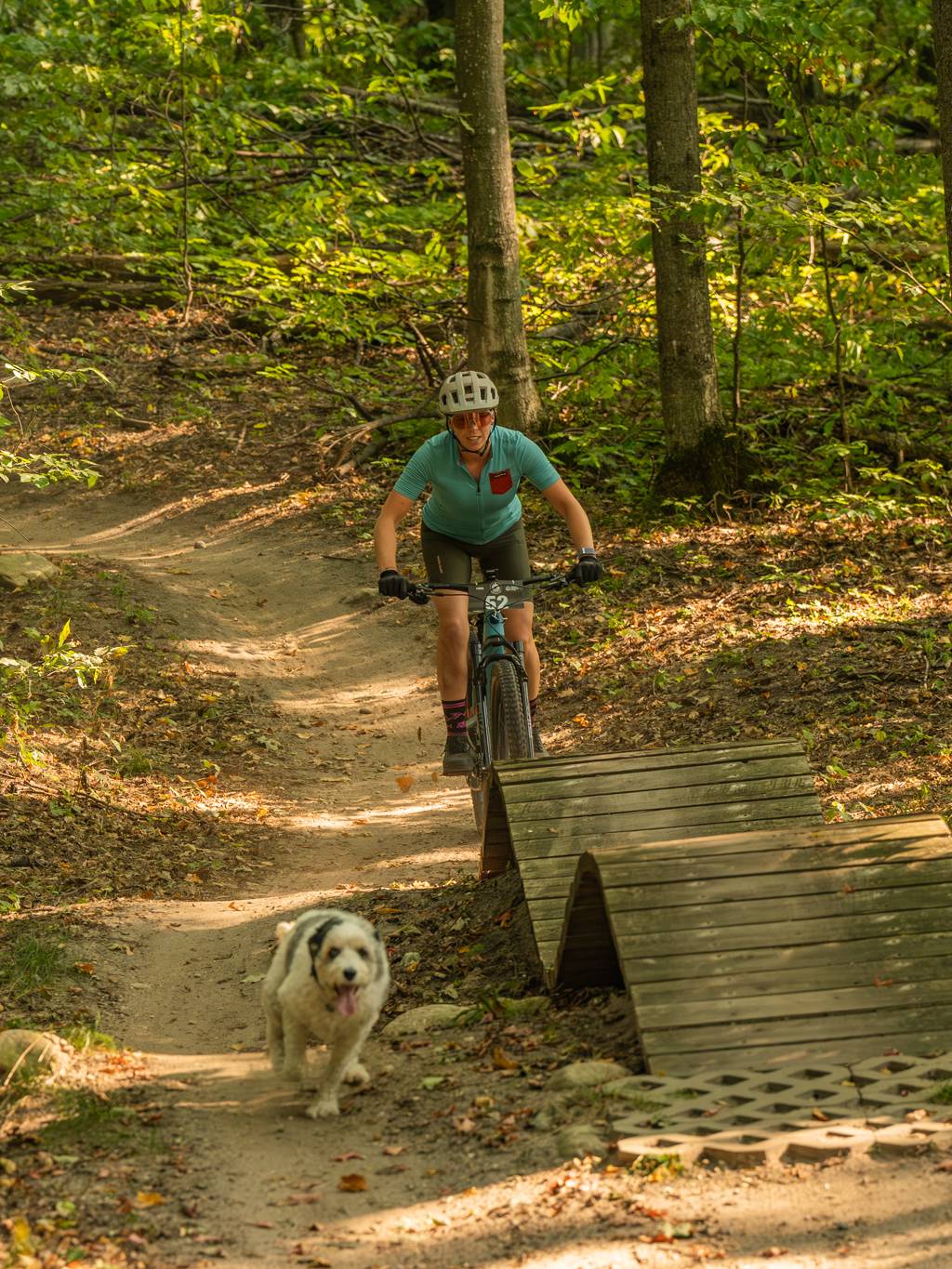 woman riding mountain bike with dog