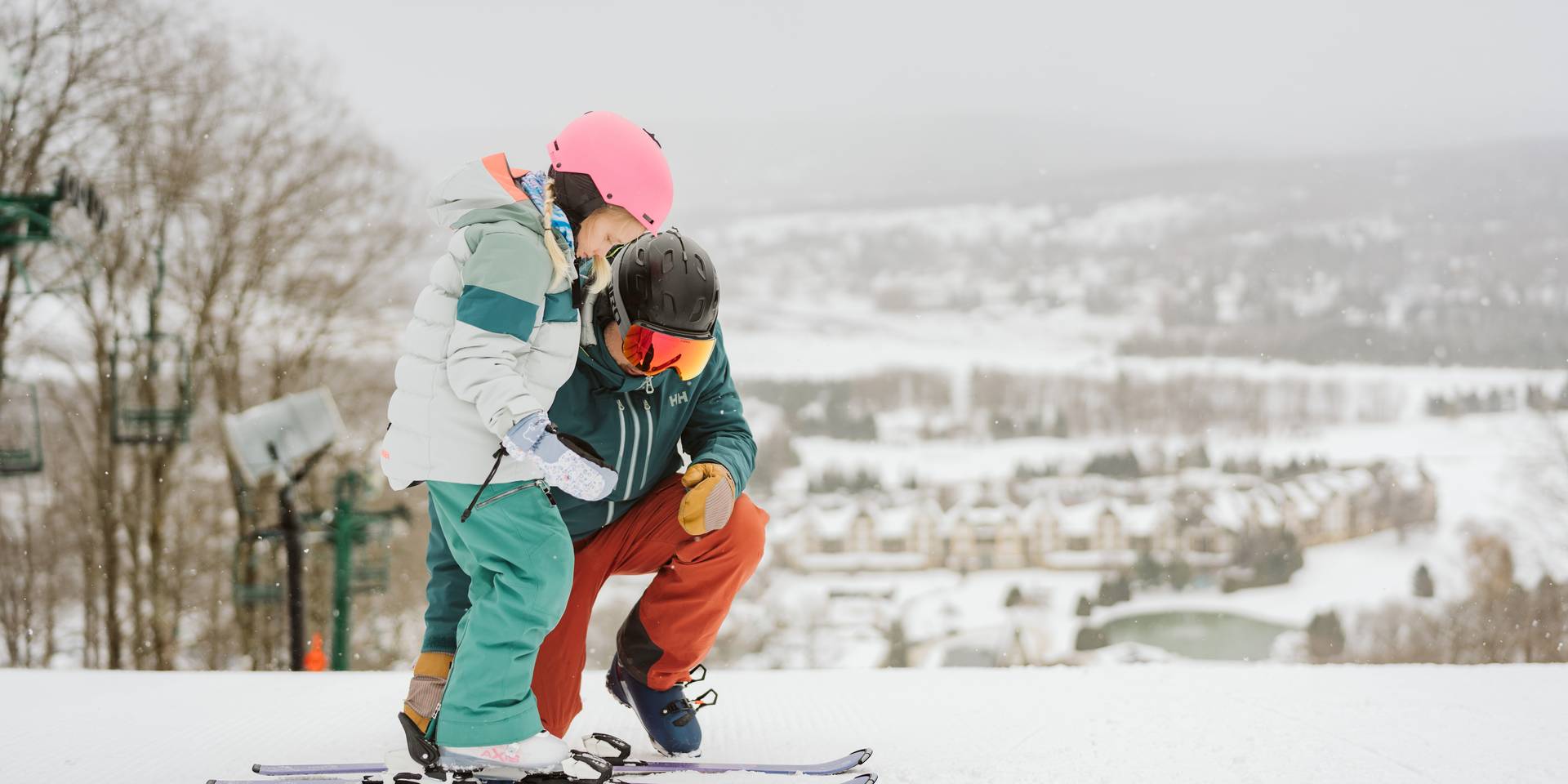 young skier getting clipped into bindings