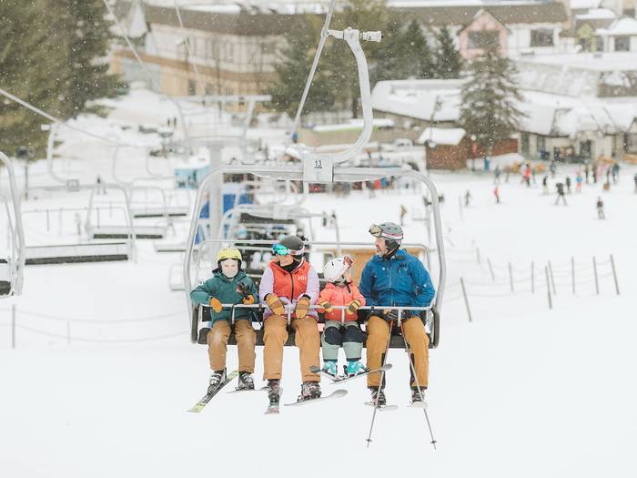 family riding chairlift at boyne mountain