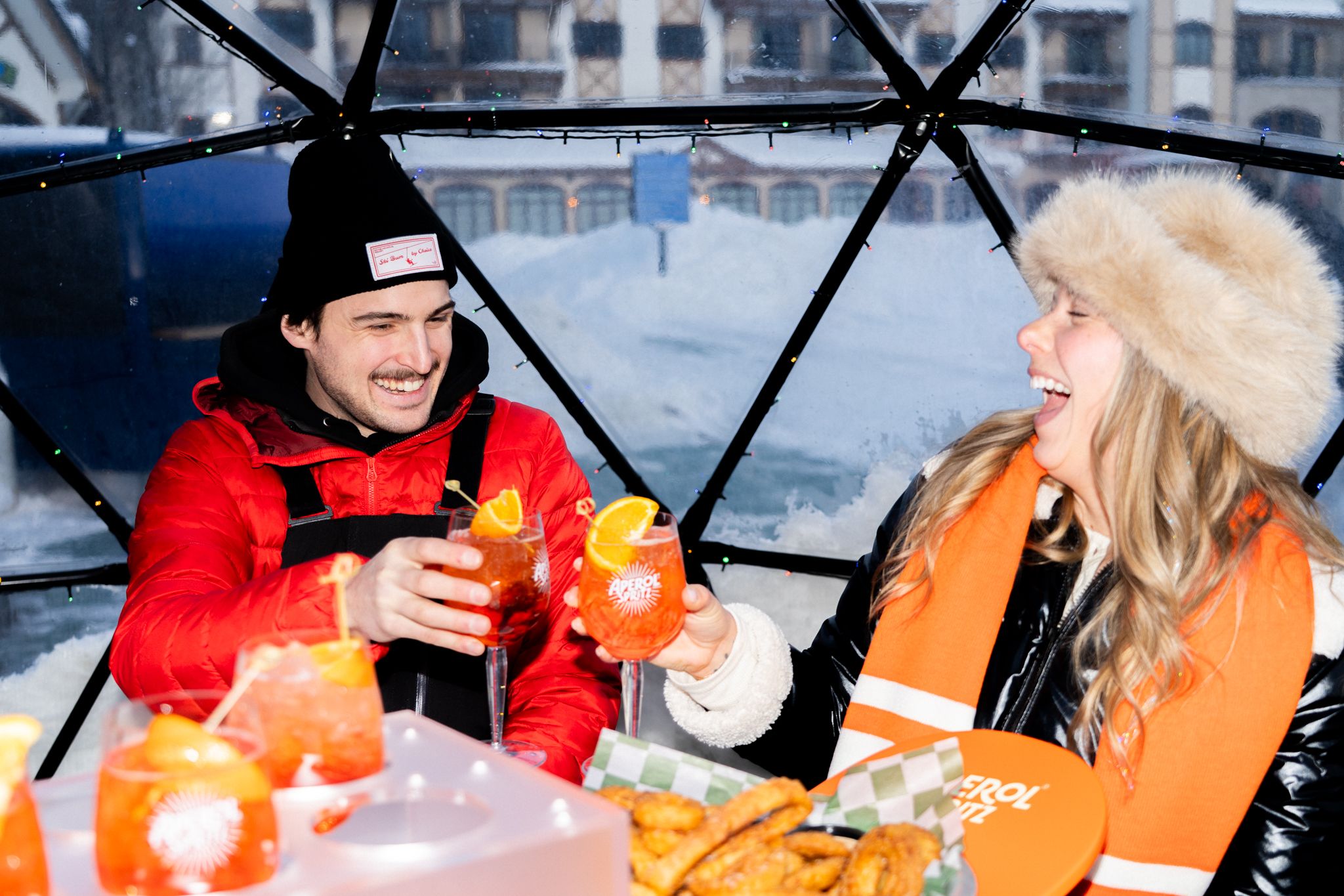 couple toasting inside igloo