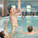 dad playing with kids in pool