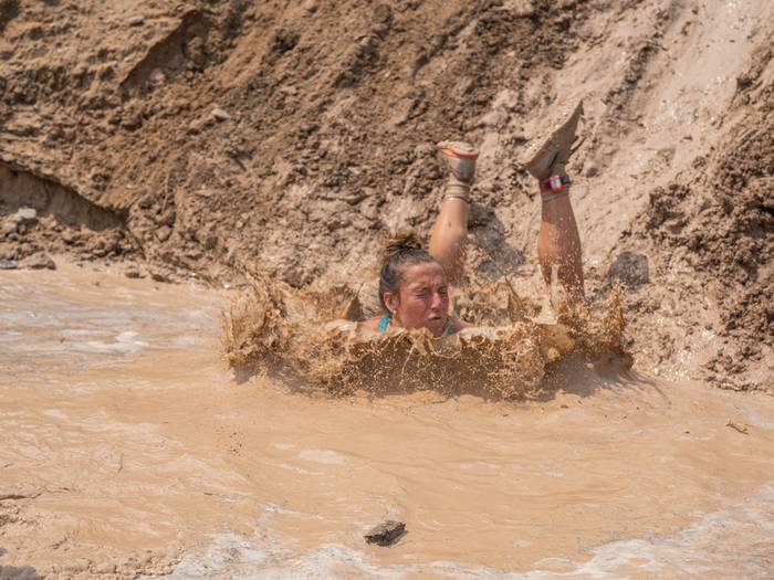 Racer sliding face first into mud pit