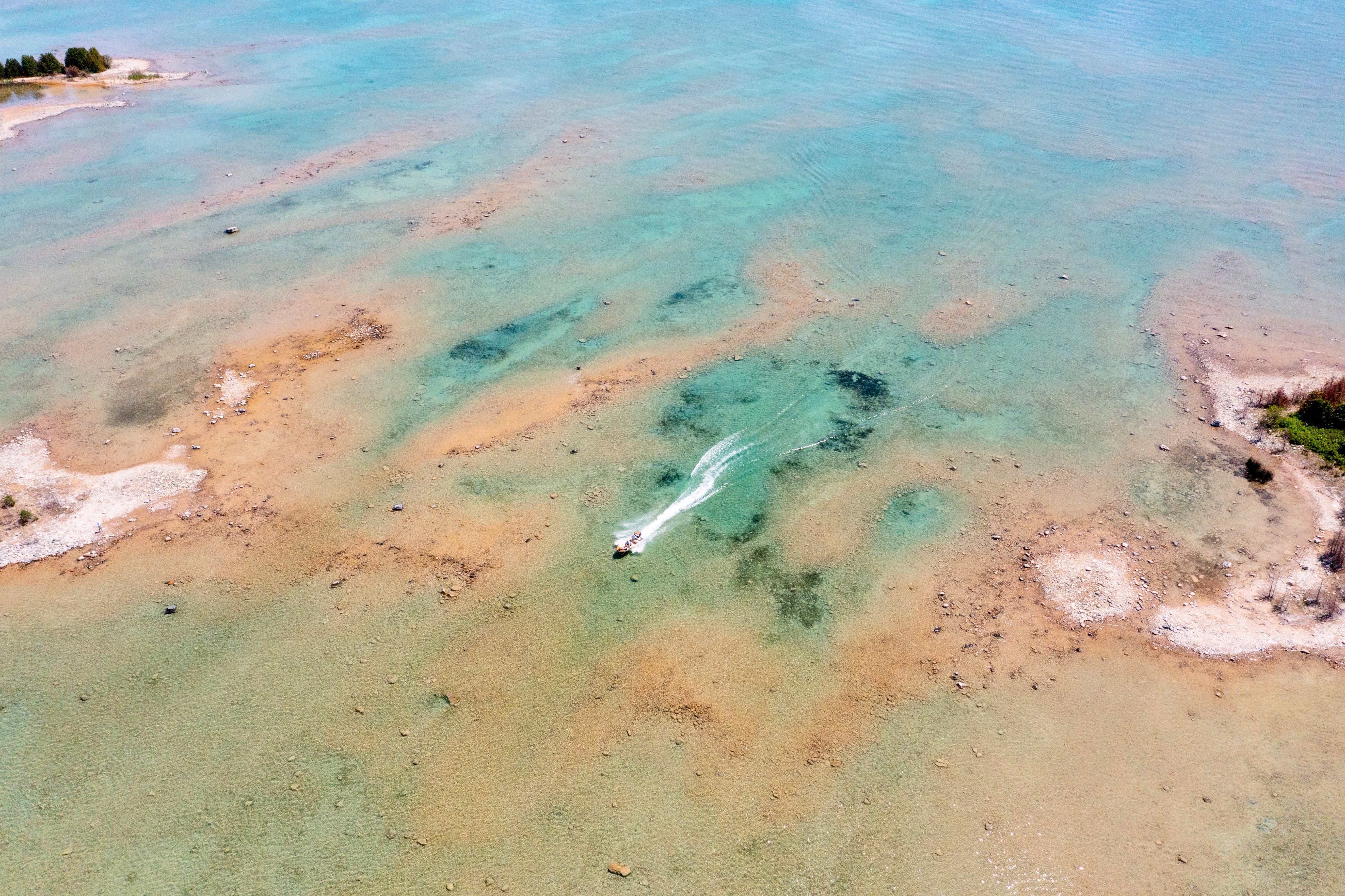 Boat speeding through water on Sturgeon Bay.