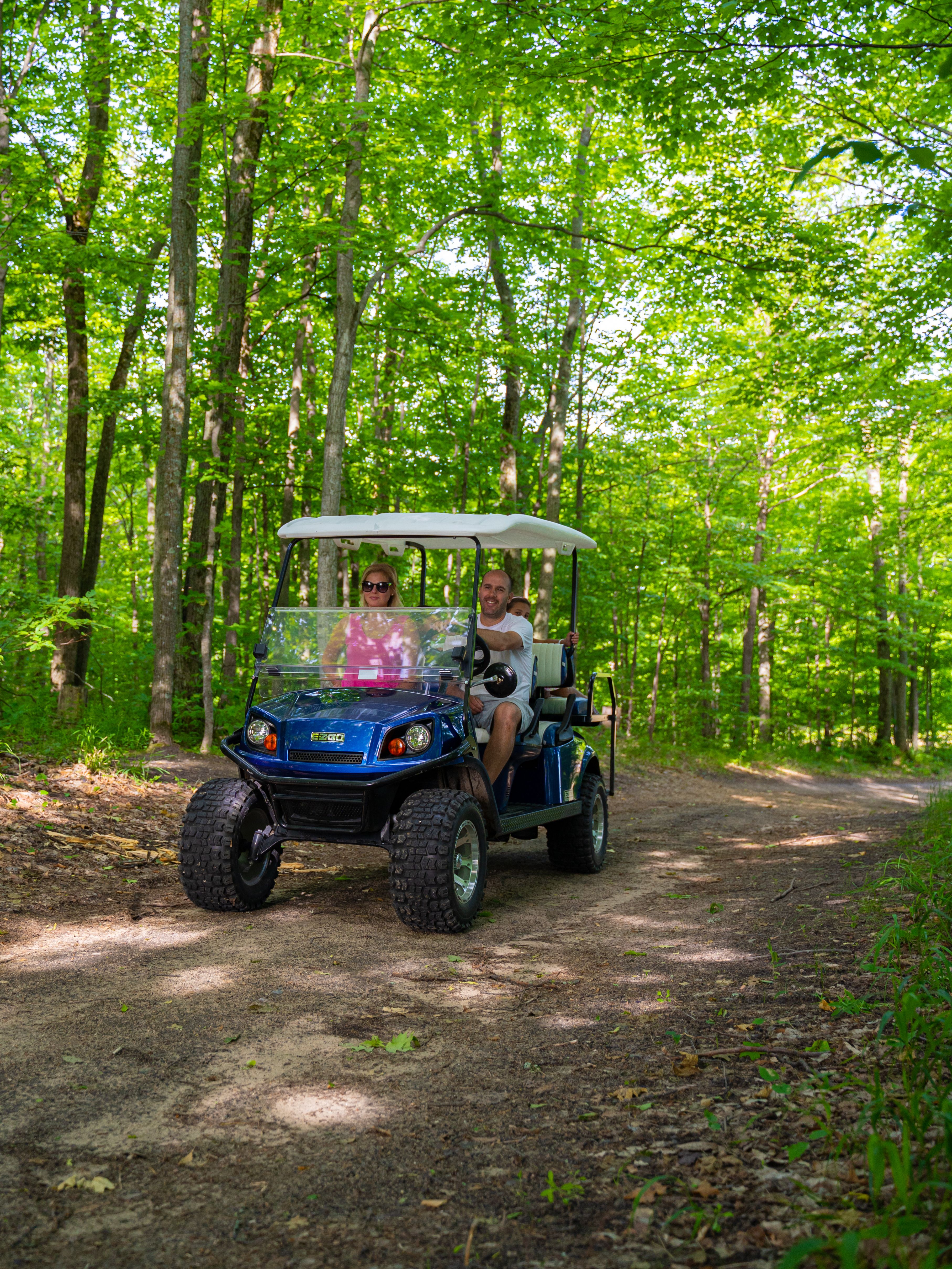 Family on scenic cart riding on a dirt trail