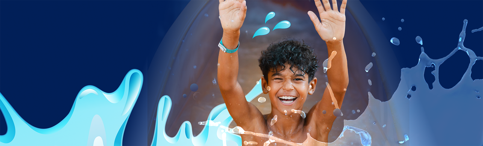 Boy with hands up on waterslide with graphics