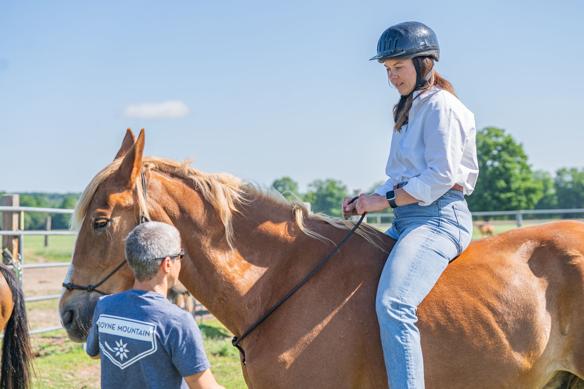 lady on horse taking instruction from guide