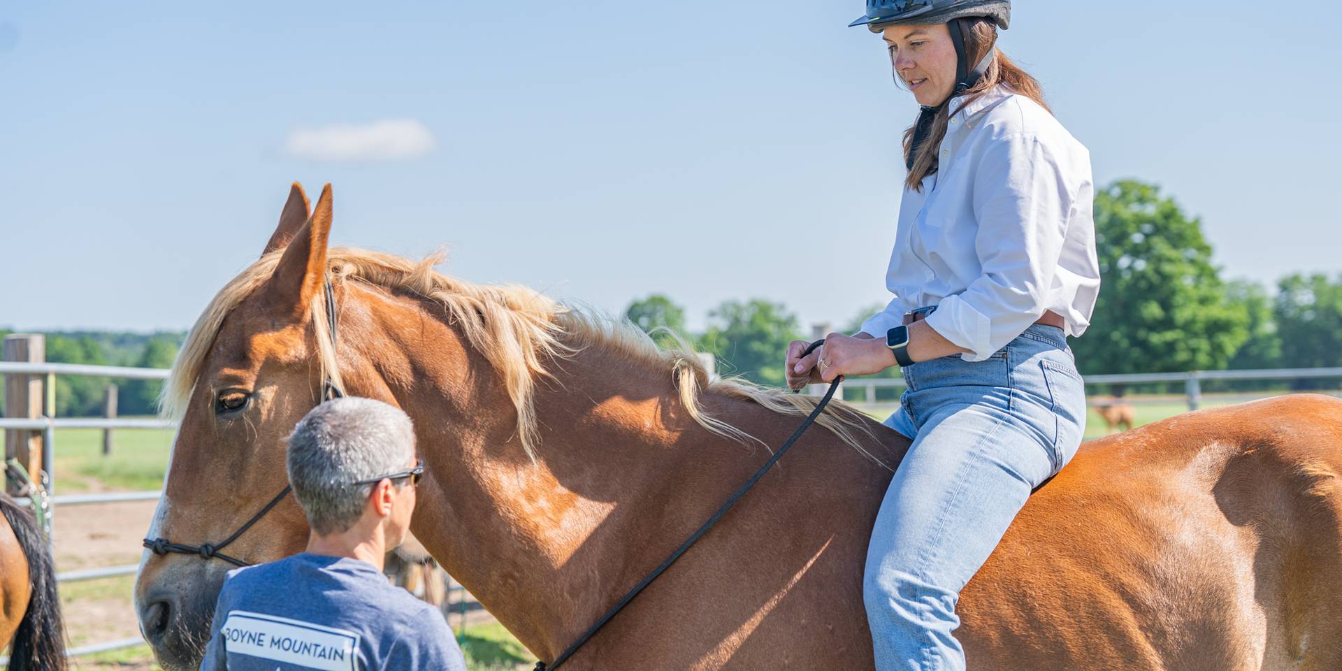 lady on horse taking instruction from guide