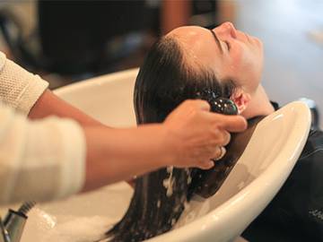Woman getting hair washed at The Spa