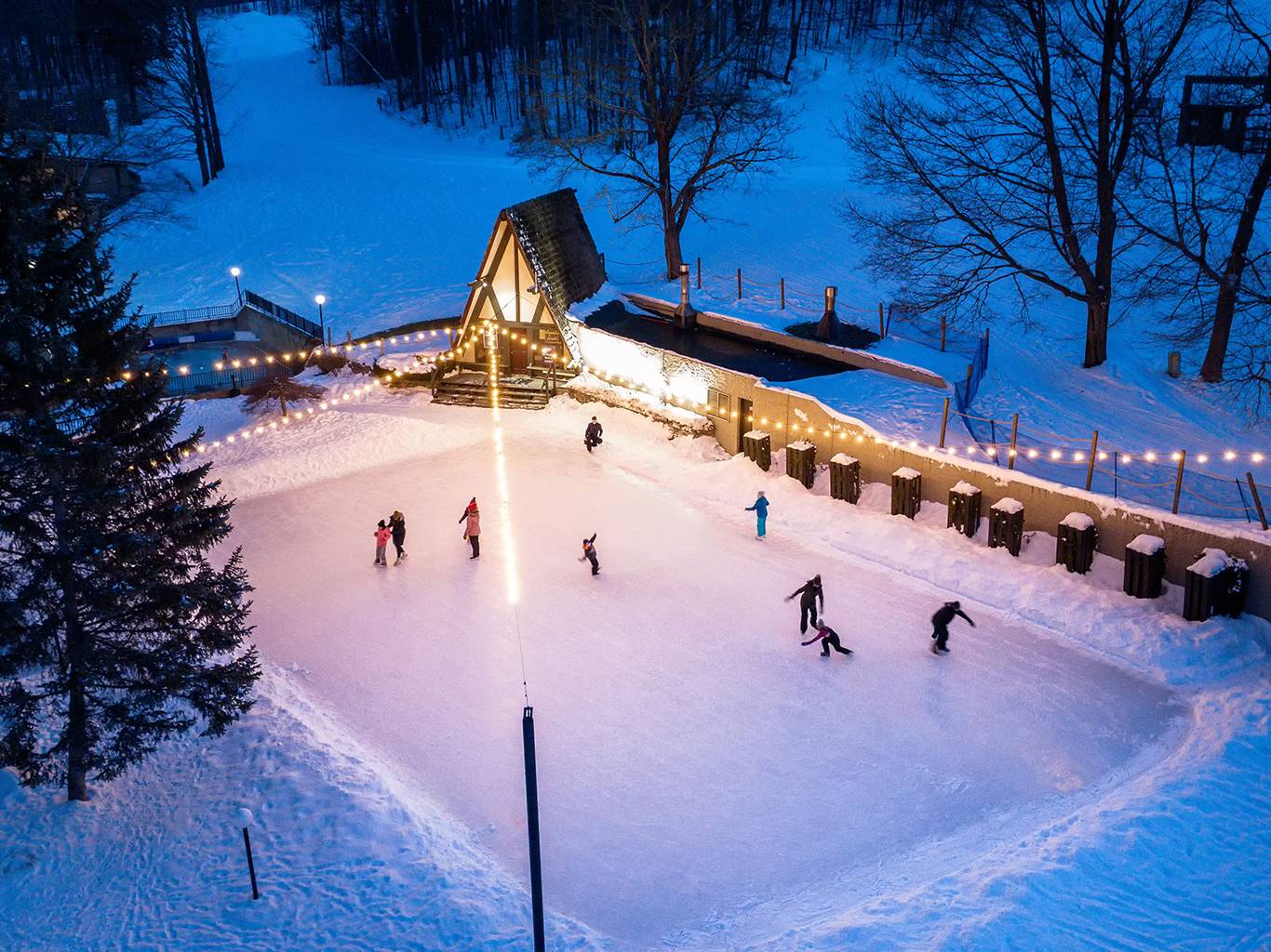 Arial view of ice skating behind the Clock Tower Lodge