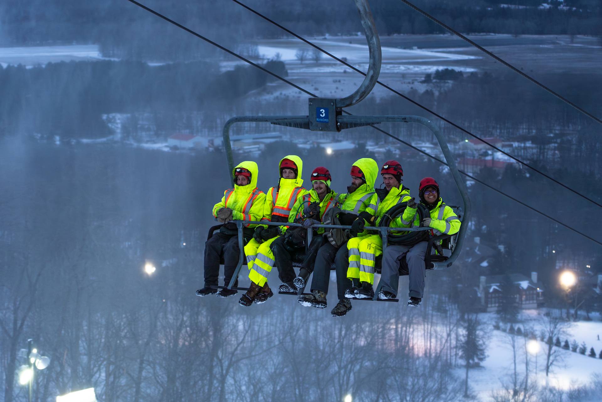 Snowmaking team on a chairlift