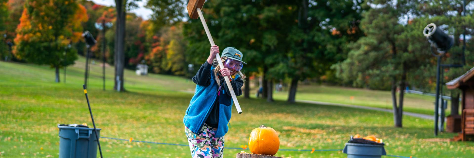 Lady smashing a pumpkin