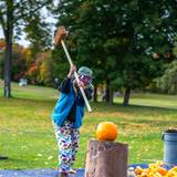 Lady smashing a pumpkin