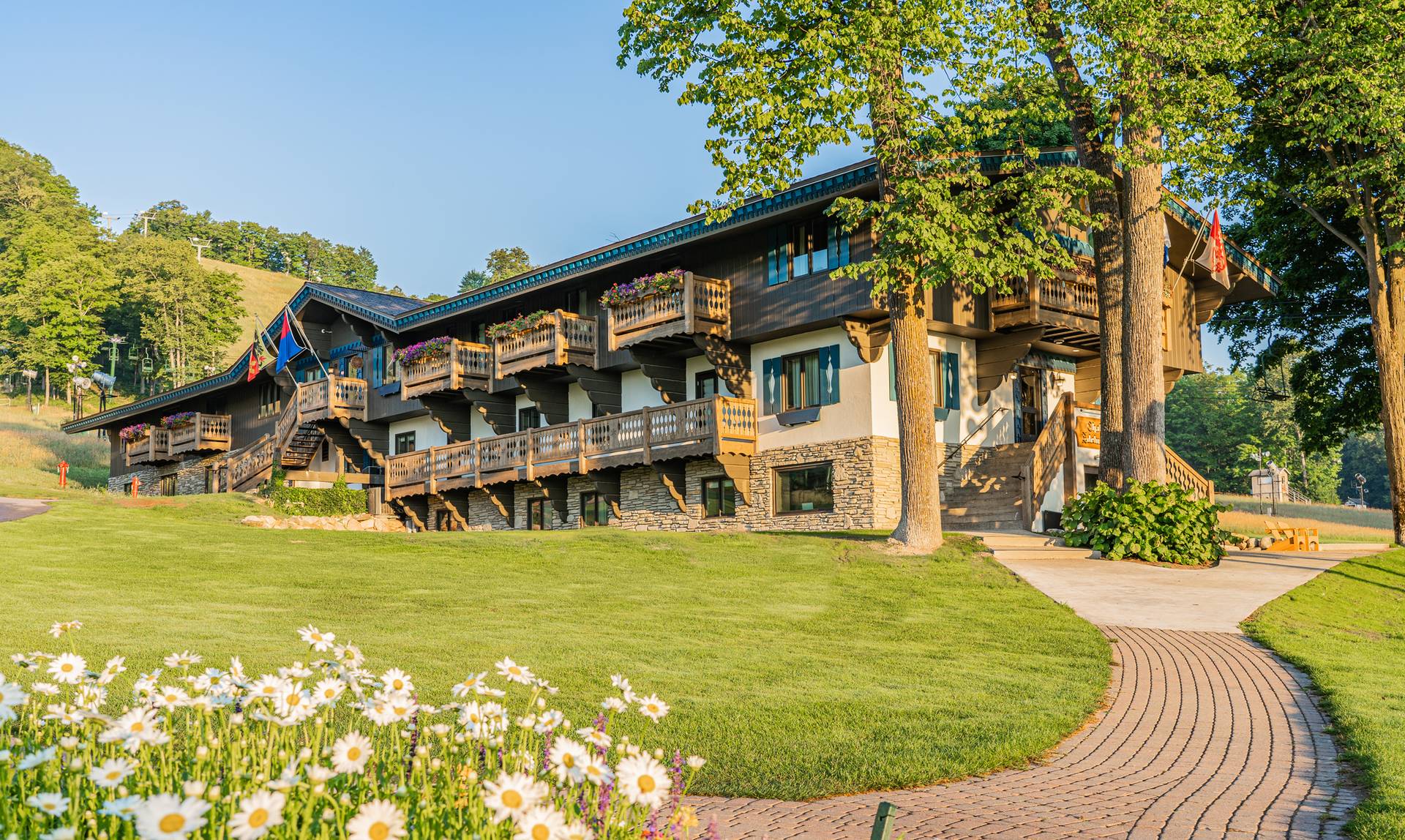 Morning sunlight and flower blooms along the path to Chalet Edelweiss