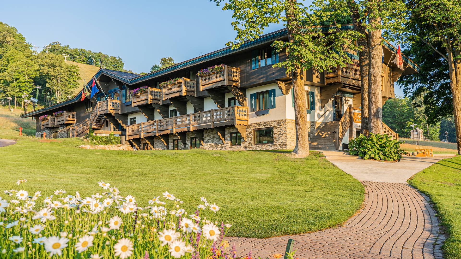 Morning sunlight and flower blooms along the path to Chalet Edelweiss