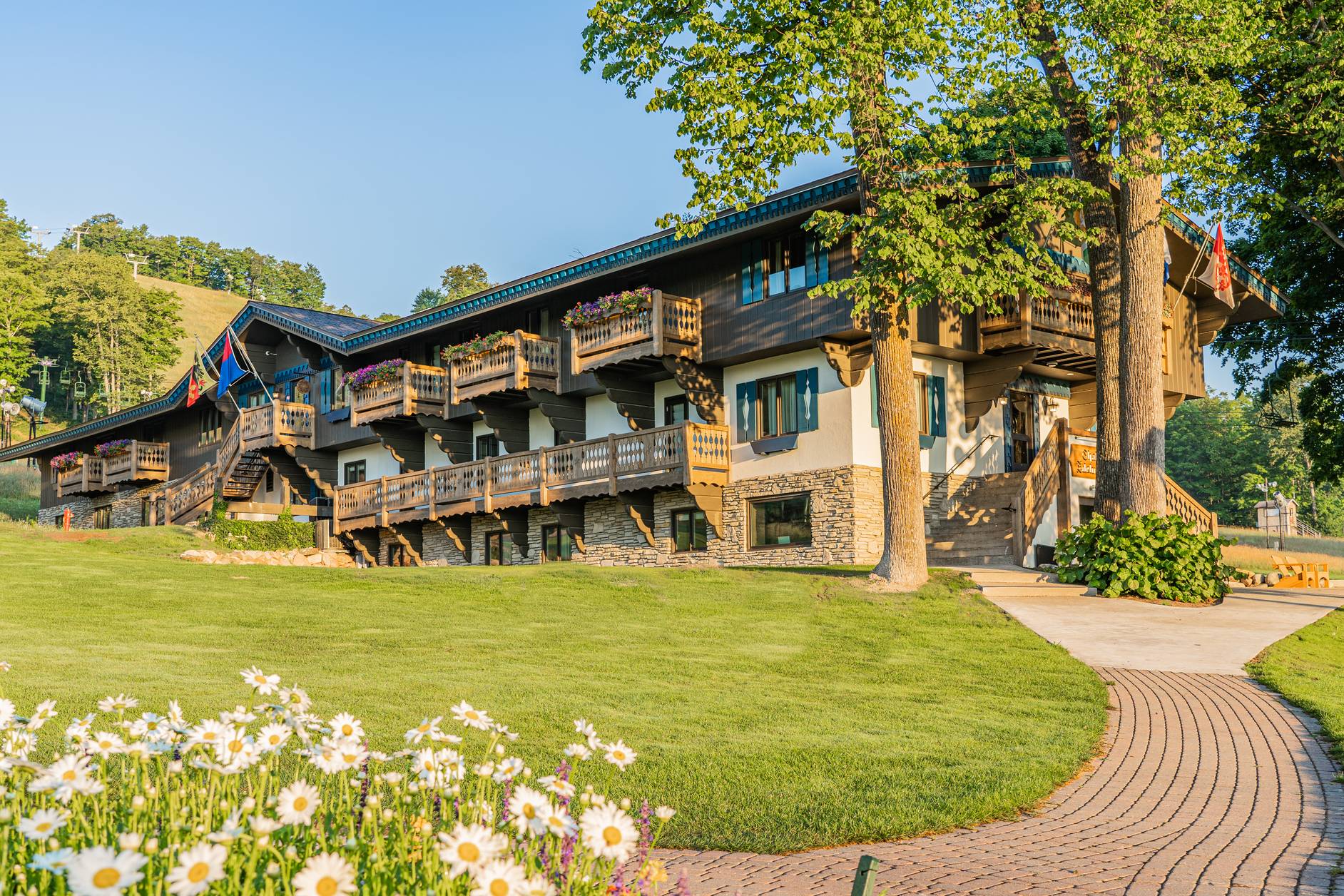 Morning sunlight and flower blooms along the path to Chalet Edelweiss