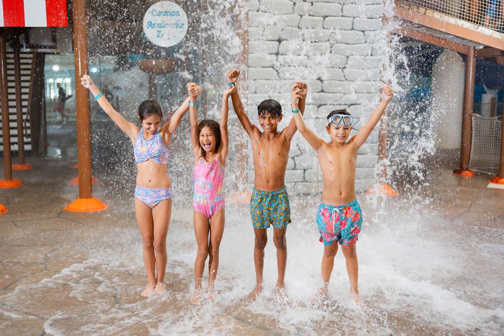 kids getting splashed at waterpark